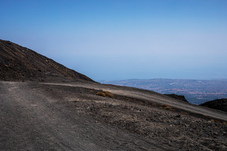 Beautiful scenery of Sicily and a road with the active volcano Etna during the day. Traveling in Italyの写真素材