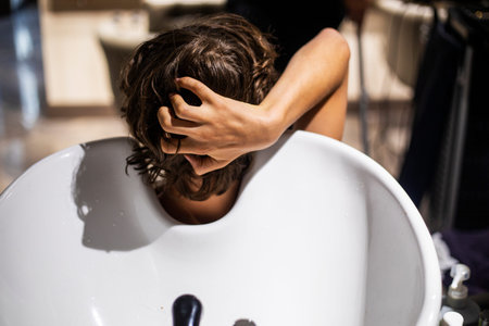 washing her hair before a haircut at a beauty salonの写真素材