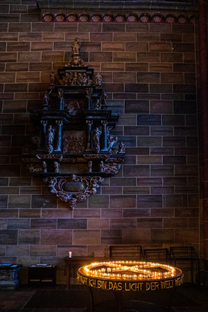 Candles in candlesticks in a church next to other candles. Religious holiday, memorial day.
