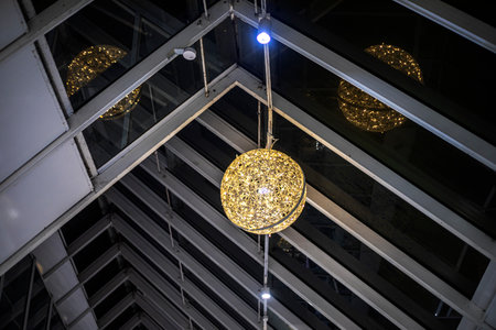 Stylish round pendant floor lamps in a modern shopping center interiorの写真素材