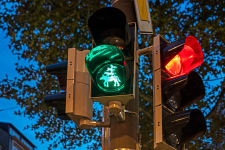 traffic light with green figures of Bremen musicians allowing pedestrians to cross the road....