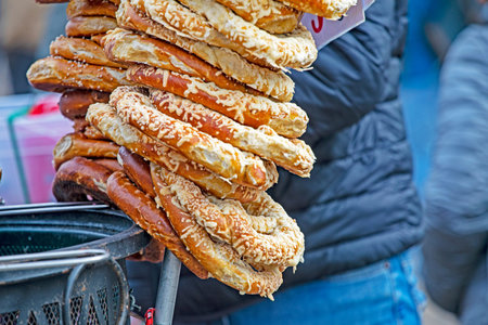 Fresh traditional pretzels sprinkled with cheese and salt.