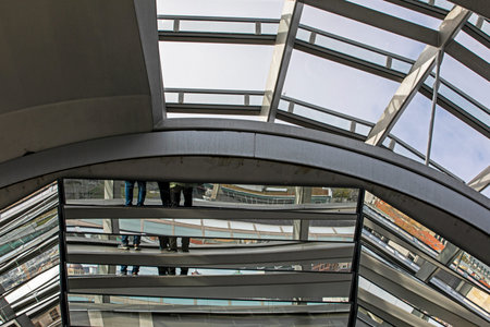 Stylish construction using metal, glass, and mirrored materials in contrasting shapes.