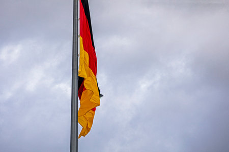German flag close-up against a cloudy skyの写真素材