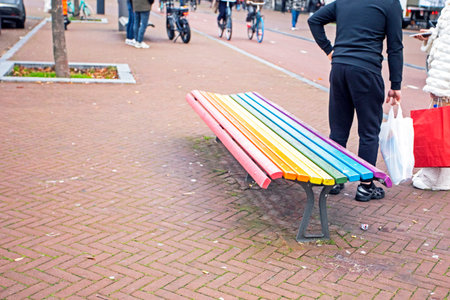 rainbow-colored bench in LGBT colors for a person to sit on in the city.の写真素材