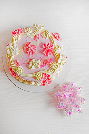Beautiful strawberry mousse cake with decorative flowers.の写真素材