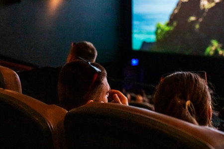 loving couple watching a movie at the cinemaの写真素材