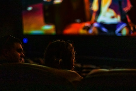 loving couple watching a movie at the cinemaの写真素材
