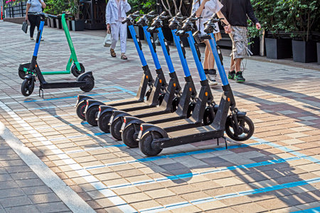 Electric scooters in a city parking lot on a sunny day