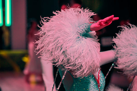Dancers in bright, beautiful dresses practicing on the dance floor