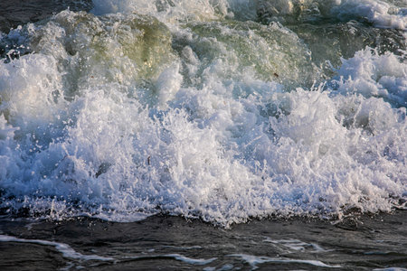 Sea foam on fine yellow sand. Storm at sea. View from above. Seaside vacation.