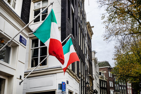 Two Italian flags on a building outside. Traveling in Europeの写真素材