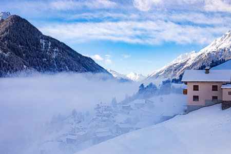 Beautiful sunny, snowy mountain landscape in the clouds near a ski resort in Austria