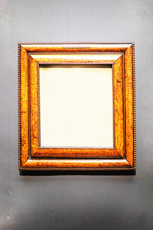 Gilded rectangular wooden frame on a gray background. Mockup for your text