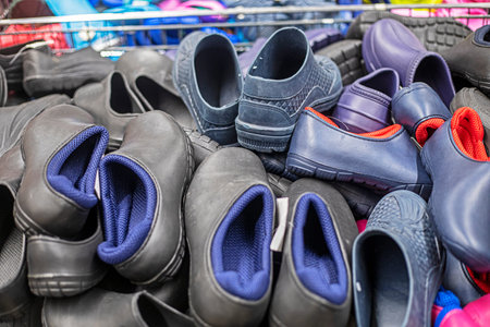 Black rubber boots in a container at the supermarket