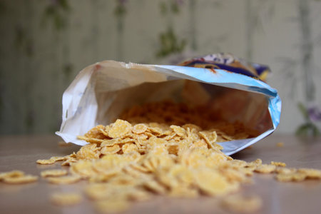the pack of corn flakes overturned on a table