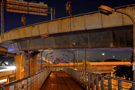 Crossing under the freeway bridge with night illumination , Bangkok, Thailand .の写真素材