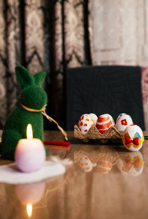 Colorful Easter decorations with painted eggs and a bunny centerpiece arranged on a festive tableの写真素材