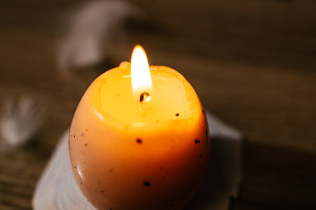 Candle flickers warmly in a cozy setting creating a tranquil atmosphereの写真素材