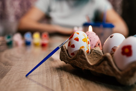 Colorful eggs and painting tools displayed on a table during an art activity for Easter celebrationの写真素材
