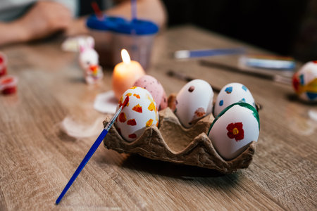 Colorful eggs in a carton during a festive gathering at home with family members celebrating Easter in the afternoonの写真素材