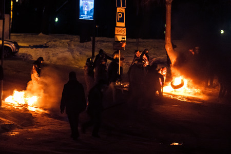 KIEV  KYIV , UKRAINE - JANUARY 26, 2014  Unidentified people taking part in anti-goverment protests in Kiev, Ukraine  Protesters defend barricades and burn tires のeditorial素材