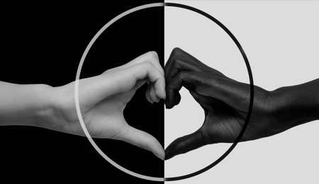 Black hand on a white background, white on black, joined in the shape of a heart and United in a circle icon. The concept of interracial friendship and respect, the fight against racismの写真素材