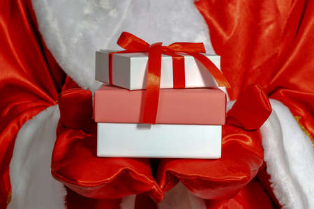 Santa Claus holds out his hands with gifts. Close-up, selective focus. The Concept Of A Happy Christmas.の写真素材