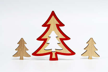 Christmas trees made of natural wood, isolated on a white background with a soft shadow. The concept of Christmas decorations.の写真素材