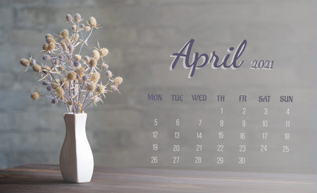 Calendar-page for the full month: April 2021. A composition of dried flowers in a white porcelain...