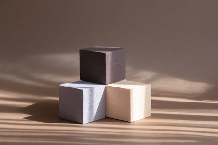 3d podium, for presentations of packaging, cosmetics. Three cubes of different colors, beige, white,...