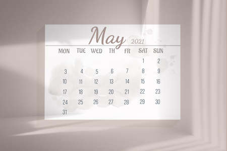 Page from the full-month calendar: May 2021. White sheet of paper with blotches on minimalistic pink background, shadows from the sunlight.Concept of calendar date, time planning. 3d illustration.の写真素材