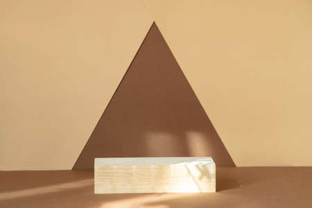 Rectangular wooden shelf for displaying goods on abstract two-color background. Concept of 3d podium for presentation of cosmetic products.の写真素材