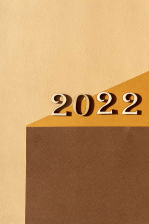 Wooden numbers 2022 on abstract brown background. Concept of welcome to NEW YEAR. Vertical image.の写真素材
