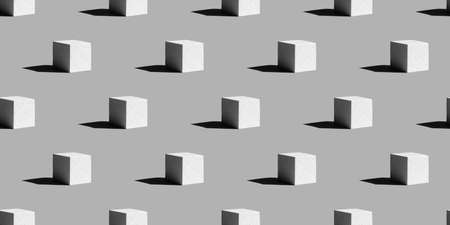 Seamless drawing of an improvised 3d podium with a hard shadow falling from it on a gray background. Abstract monochrome photography.の写真素材