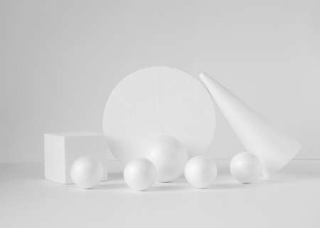 3D composition of geometric shapes. White cones, spheres, circle, square podium on isolated light background. abstract close-up.の写真素材