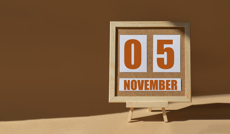 November 5th. Day 5 of month, Calendar date. Cork board, easel in sunlight on desktop. Close-up, brown background. Autumn month, day of year conceptの写真素材