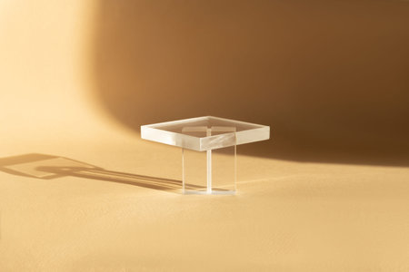 Transparent stand for demonstration of skin care products. 3d podium for presentation of cosmetic products for online marketing on beige background with reflection.の写真素材