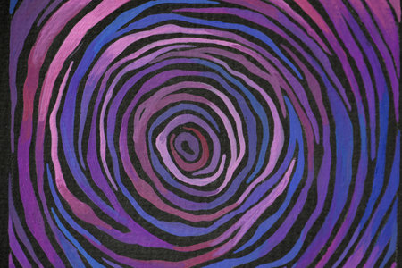 Multicolored circular lines highlighted on black background. Abstraction of cosmic planet. Purple swirling spiral.の写真素材
