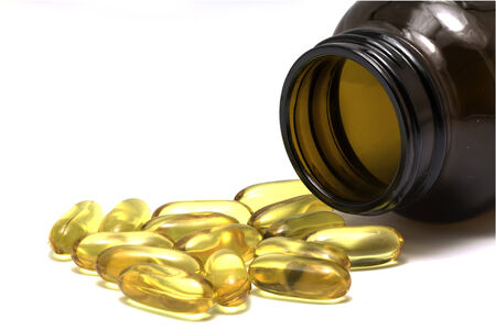 medicine from container isolated on white backgroundの写真素材