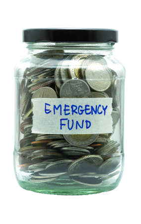 isolated coin in jar with emergency fund labelの写真素材