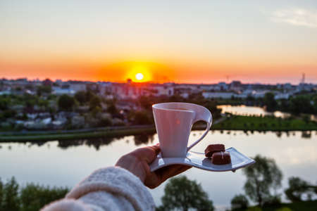 cup of coffee on a background of sunriseの写真素材