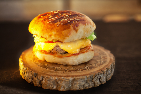 homemade burger on wooden board. Sunset light.の写真素材
