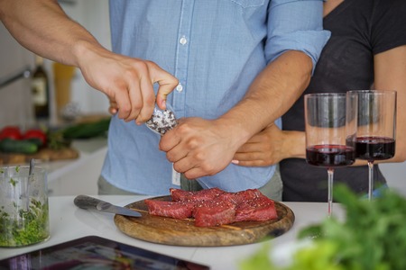Couple Cooking meat together. Hobby Lifestyle Concept.の写真素材