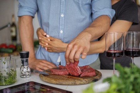 Couple Cooking meat together. Hobby Lifestyle Concept.の写真素材
