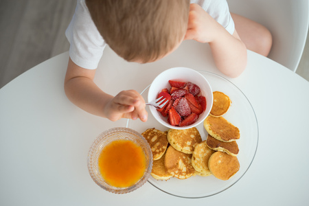 The child has Breakfast on a Sunny morningの写真素材