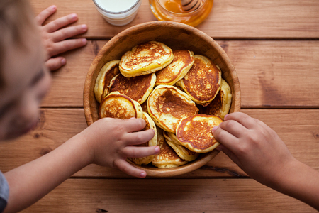 delicious pancakes on wooden table with berries and fruitsの写真素材