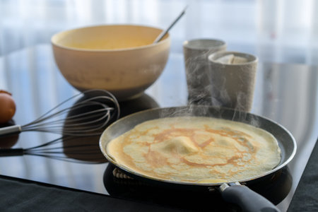 Ingredients for pancake on a black glossy background. Pancake day.
