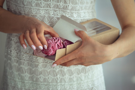 Woman holding marshmallows in a cardboard box