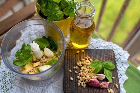 Homemade parsley pesto sauce and ingredients on wooden background.の写真素材